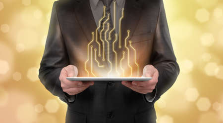 Businessman standing on blurry yellow background presenting new technologies of line diagram. New...