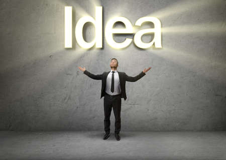 Businessman raised his hands up to emphasize the Idea. Formation of ideas. Business concept. Inspiration. Process of thinking.の写真素材