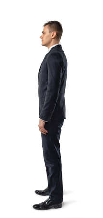 Side view of businessman standing, isolated on white background. Successful lifestyle. Business staff. Office clothes. Dress code. Presentable appearance. Self-confidence.の写真素材