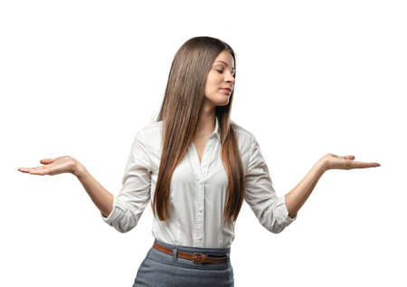 ?ut-out businesswoman throws her hands up. Innocence. To be out of something. Situation is out of control. Not to be in the know. Half-length portrait of girl shrugging shoulders. Innocence. Business staff. Office clothes.の写真素材