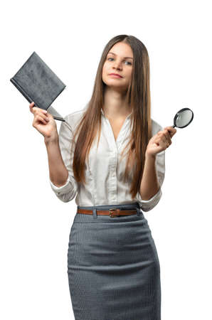 Cutout business woman holding a book and magnifier. Smart staff. Success and development. Business staff. Office clothes. Learning and teaching. Study process.の写真素材