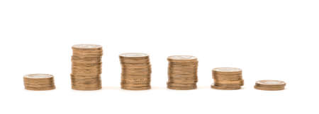 Stacks of golden coins in a row isolated on white background.の写真素材