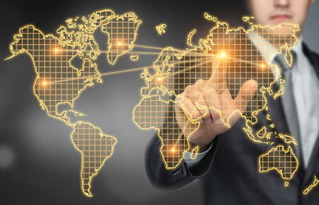 Businessman touching the digital touchscreen with world map with his finger.