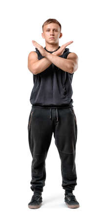 Full body portrait of handsome muscled young man making X sign with his arms isolated on white background.の写真素材