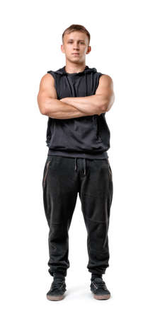 Full body portrait of handsome muscled young man with folded arms isolated on white background.の写真素材