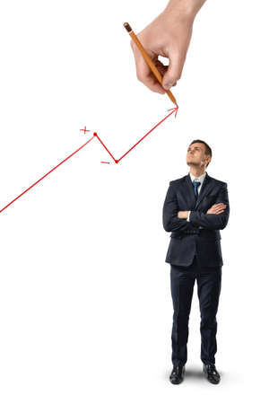 Businessman stands with folded arms looking upwards at big hand drawing rising diagram isolated on white background.の写真素材