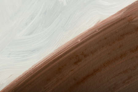 Piece of a pained picture with diagonally located white and brown colors.の写真素材