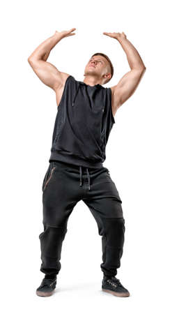 Full body portrait of handsome muscled young man pushing invisible wall under pressure isolated on white background.の写真素材
