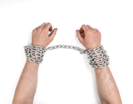 Close up view of chained man's hands.の写真素材