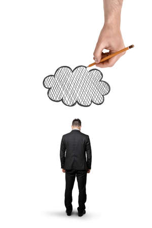Back view of a businessman with bowed head standing and a big hand above that draws a cloud isolated on white background.の写真素材