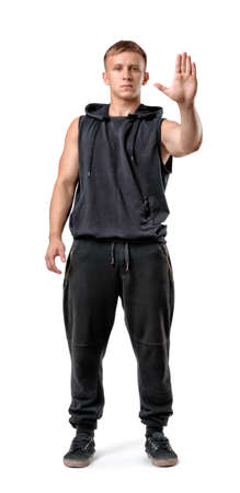 Full body portrait of handsome muscled young man showing stop hand sign isolated on white background.の写真素材