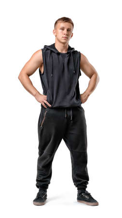 Full lenght portrait of muscled young man with his hands on hips, isolated on white background. Workout, fitness, sport. Healthy lifestyle. Strength.の写真素材