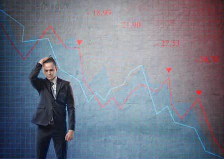 Businessman with his hand on his head looking puzzled on the background of stock market crashing.の写真素材