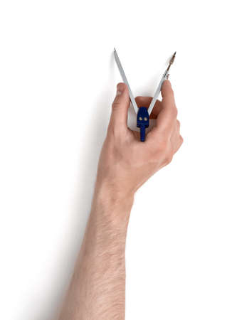 Close-up view of a man's hand with drawing compass, isolated on white background.の写真素材