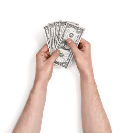 Hands of man holding one-dollar bills on white background.の写真素材