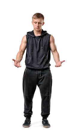 Front view of muscled young man holding something in front of him looking down isolated on white background.の写真素材