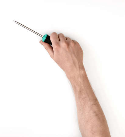 Close-up view of a man's hand with a screwdriver, isolated on white background.の写真素材