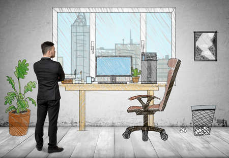 Back view of a businessman standing in hand drawn office looking out the window.の写真素材
