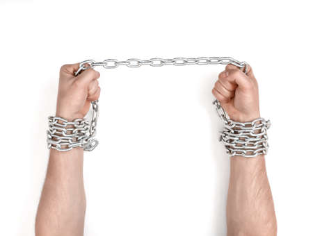 Close up view of chained man's hands.の写真素材