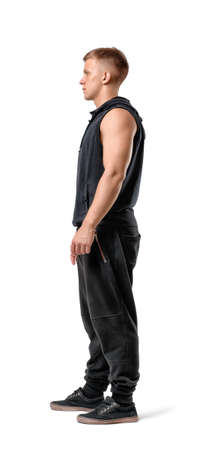 Side view of muscled young man standing, isolated on white background.の写真素材