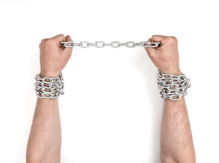 Close up view of chained man's hands.の写真素材