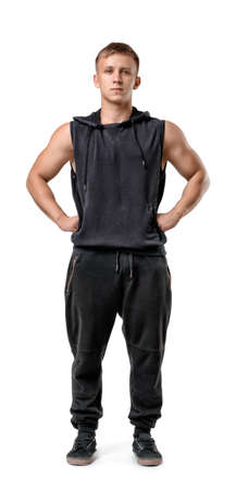 Full length portrait of muscled young man with his hands on hips, isolated on white background.の写真素材