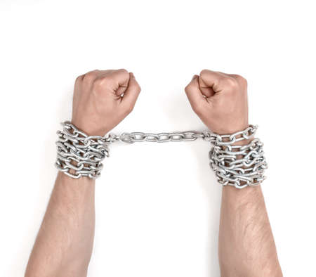 Close up view of chained man's hands. Fetter and captivity. Lack of freedom.の写真素材