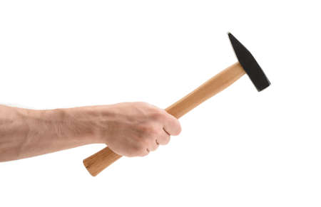 Close-up view of a man's hand holding hammer, isolated on white background. Repairing and...