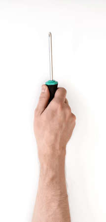 Close-up view of a man's hand with a screwdriver, isolated on white background. Repairing. Man's work. Maintenance. Tools and equipment.の写真素材