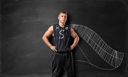 Muscled young man with drawn capeの写真素材