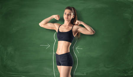 Cropped portrait of fitness girl showing her biceps with drawn fat around her body on the background...