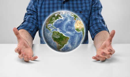 Cropped portrait of a man holding Earth in his hands. Environment protection. Ecological impact. Global communication. Elements of this image are furnished by NASA.の写真素材