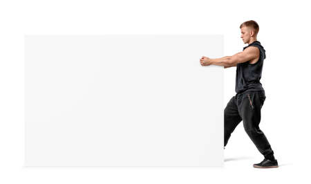 Muscular man holding a clear white display board with his fists.の写真素材