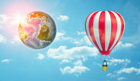 3d rendering of a large striped air balloon in the sky beside an Earth globe of the same size.の写真素材
