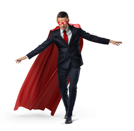 A superhero in a business suit and a red cape keeping his balance on an invisible rope.の写真素材