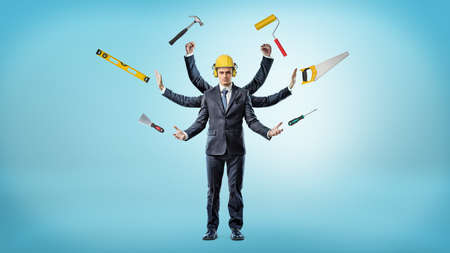A businessman with many hands that wears a hardhat surrounded by construction instruments.