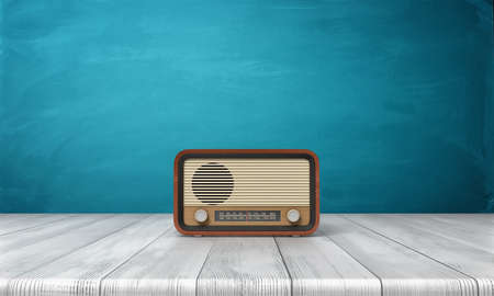 3d rendering of a brown vintage radio set standing on a white wood table in front of blue background.の写真素材