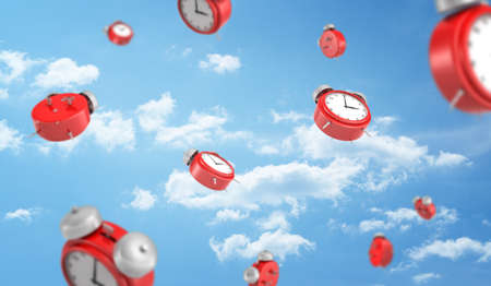 3d rendering of a many red retro-looking alarm clocks with metal bells fall down on cloudy sky background.の写真素材