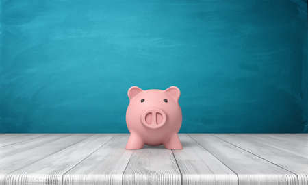 3d rendering of a pink piggy bank in front view standing on a wooden table.の写真素材