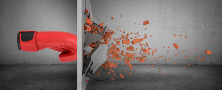 3d rendering of a huge red boxing glove in side view touches a brick wall and smashes it with rubble falling out.の写真素材