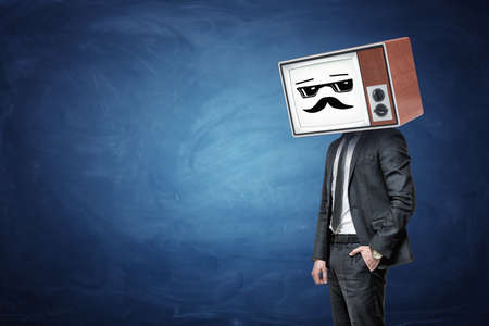 A businessman has one in a pocket and wears an old TV instead of his head, while it shows a white cool guy emoticon.の写真素材