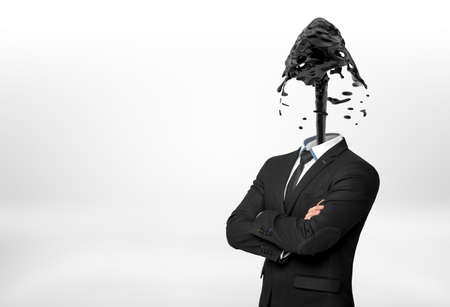 A businessman with crossed hands on white background has his head replaces with a fountain of black oil.の写真素材