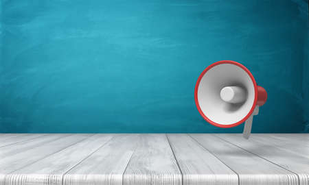 3d rendering of a single red and white megaphone hanging vertically above a wooden desk.の写真素材