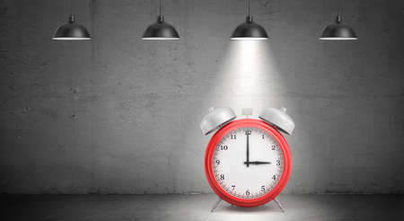 3d rendering of a large red retro alarm clock stands on dark concrete background under industrial pendant lamps.の写真素材