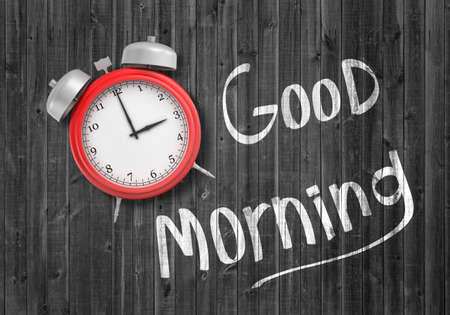 3d rendering of a top view on a red retro alarm clock lying on a wooden background near a white...