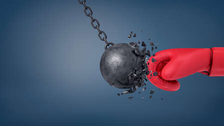 3d rendering of swinging wrecking ball crashes when collides with a huge red boxing glove.