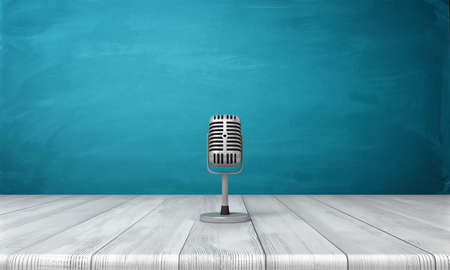 3d rendering of a single metal retro microphone placed on its short stand over a wooden desk.の写真素材