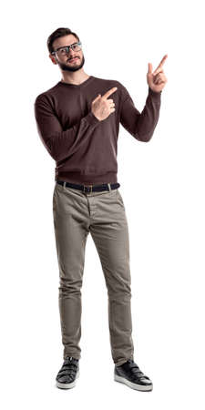 A bearded man in smart casual clothes looks in front to camera and points sideways with both hands and index fingers.の写真素材