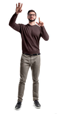 A smart looking bearded man looks up and holds his hands as if manipulating a large touch screen.の写真素材