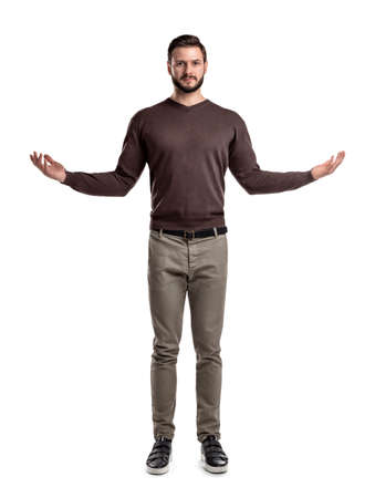 A young smart looking man stands in front view with arms widely spread on the sides.の写真素材